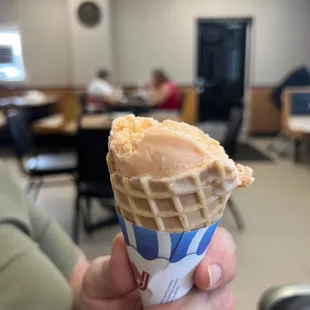 a person holding an ice cream cone