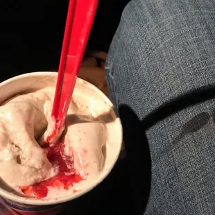 a person holding a cup of ice cream