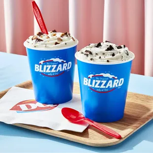 two blizzard milkshakes on a tray
