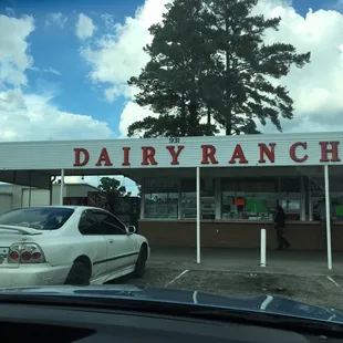 a car parked in front of a dairy ranch