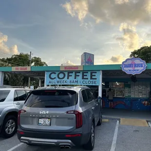 a car parked in front of a coffee shop
