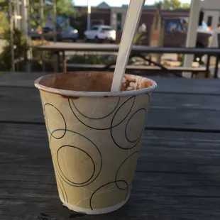 a cup of ice cream with a spoon sticking out of it