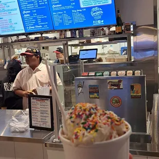 a hand holding a cup of ice cream