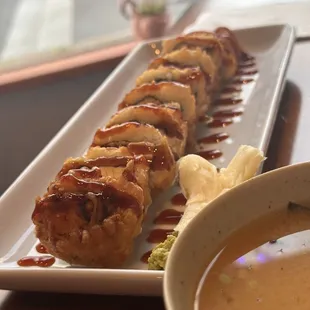 a plate of sushi and a bowl of soup
