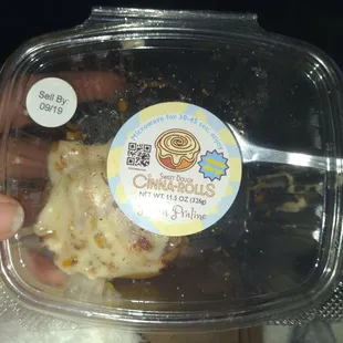 a person holding a plastic container of food