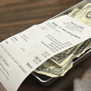 a receipt and a stack of cash