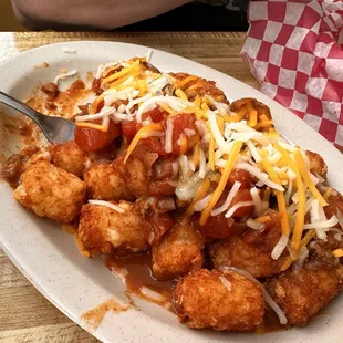 Chili cheese tater tots with onions, jalapeños and ranch dressing