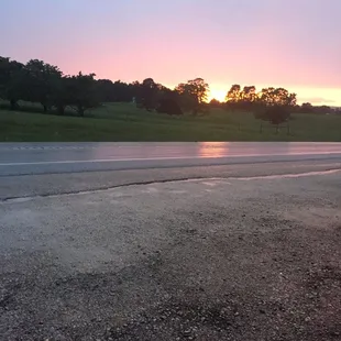 the sun setting over a road