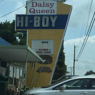 a silver car parked in front of a yellow building