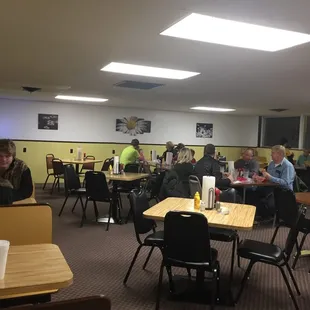 people sitting at tables in a restaurant
