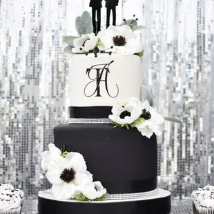 a wedding cake and cupcakes