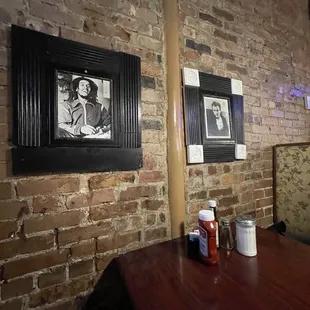 a brick wall with a picture of a baseball bat hanging on it