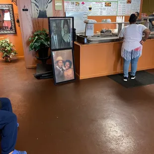 a woman sitting on a bench in front of the counter