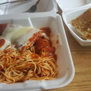 My to-go container of Chicken Parm w/ garlic bread