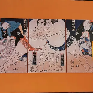 a series of paintings on a wall