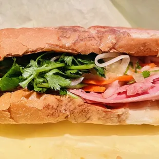 a sub sandwich with meat and vegetables