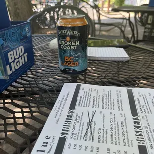 a beer and menu on a table