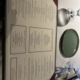 a table with a menu and a lamp