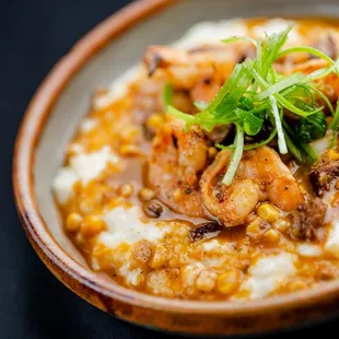 a bowl of grits and vegetables