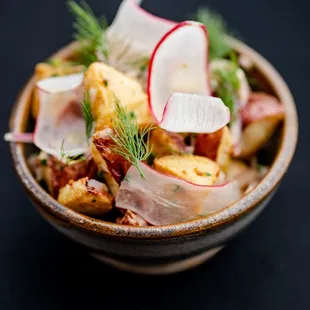 a bowl of food with radishes and cheese