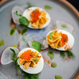 three deviled eggs on a plate