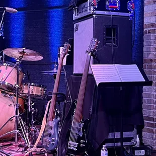 a guitar, bass, and other musical instruments on a stage