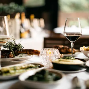 a table of food and wine glasses