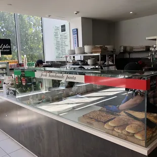 a bakery counter with a variety of pastries