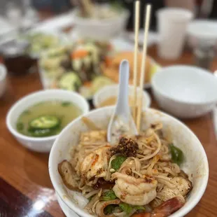 a bowl of noodles with chopsticks