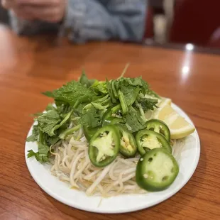 a plate of noodles with jalapenos
