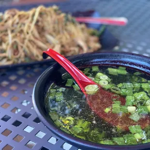 a bowl of soup and a plate of noodles