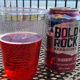 a glass of beer and a can on a table