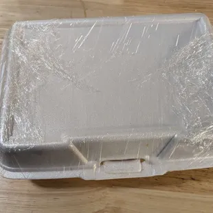 a plastic container on a wooden table