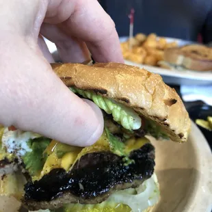 Charred burned burger that was disgusting