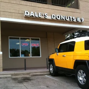  yellow jeep parked in front of a donut shop