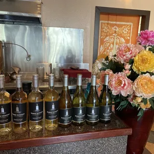 a bunch of bottles of wine on a counter