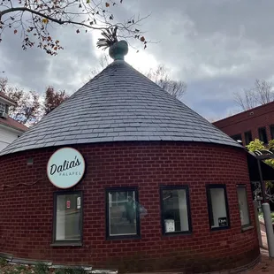 a circular building with a clock on top