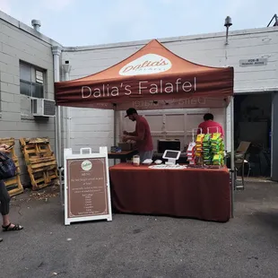 a woman standing in front of a tent