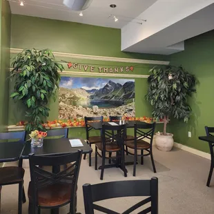 a dining area with tables and chairs