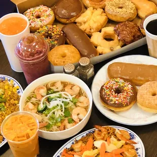 a box of doughnuts, a box of donuts, a bowl of salad, and a cup of