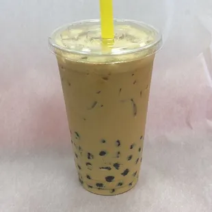 a plastic cup with a yellow straw