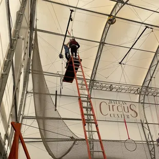 My son at the top of the trapeze getting instruction.