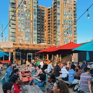 a large group of people sitting at picnic tables