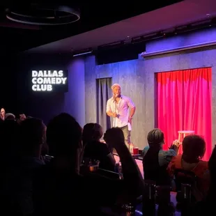 a man standing on a stage with a microphone