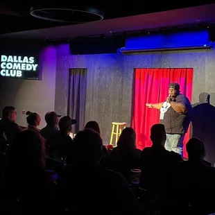 a man on stage with a microphone