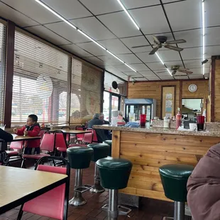 a man sitting at a table in a diner