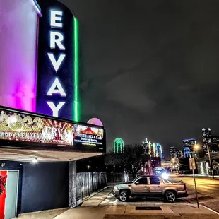 a car parked in front of a movie theater