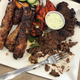 Family feast (missing the 2 giant naan it comes with). Chicken seekh kebabs, chicken boti, beef seekh kebab with raita dipping sauce.