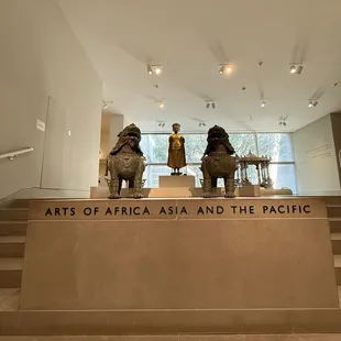 2 Pups at the entrance of the Africa, Asia and Pacific Galleries