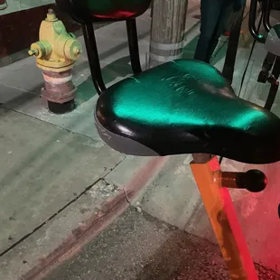 a green seat and a fire hydrant